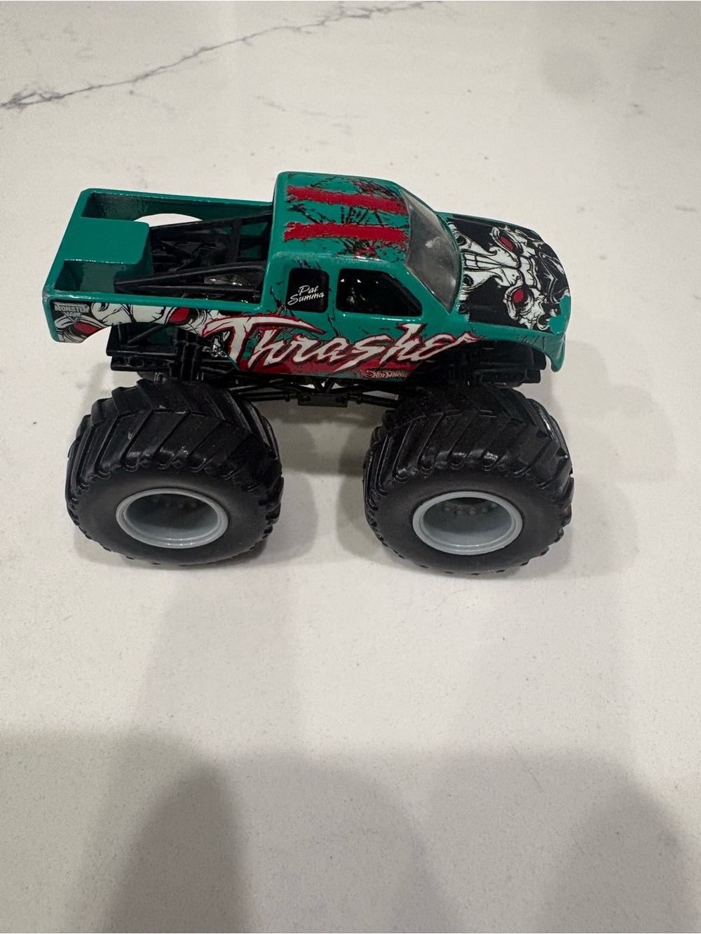 Thrasher Teal Monster Truck Toy with Black Wheels and Red Accents